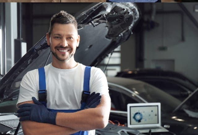 Arbeitsschutz in der Kfz-Werkstatt: Kfz-Mechaniker mit Handschuhen vor geöffneter Motorhaube